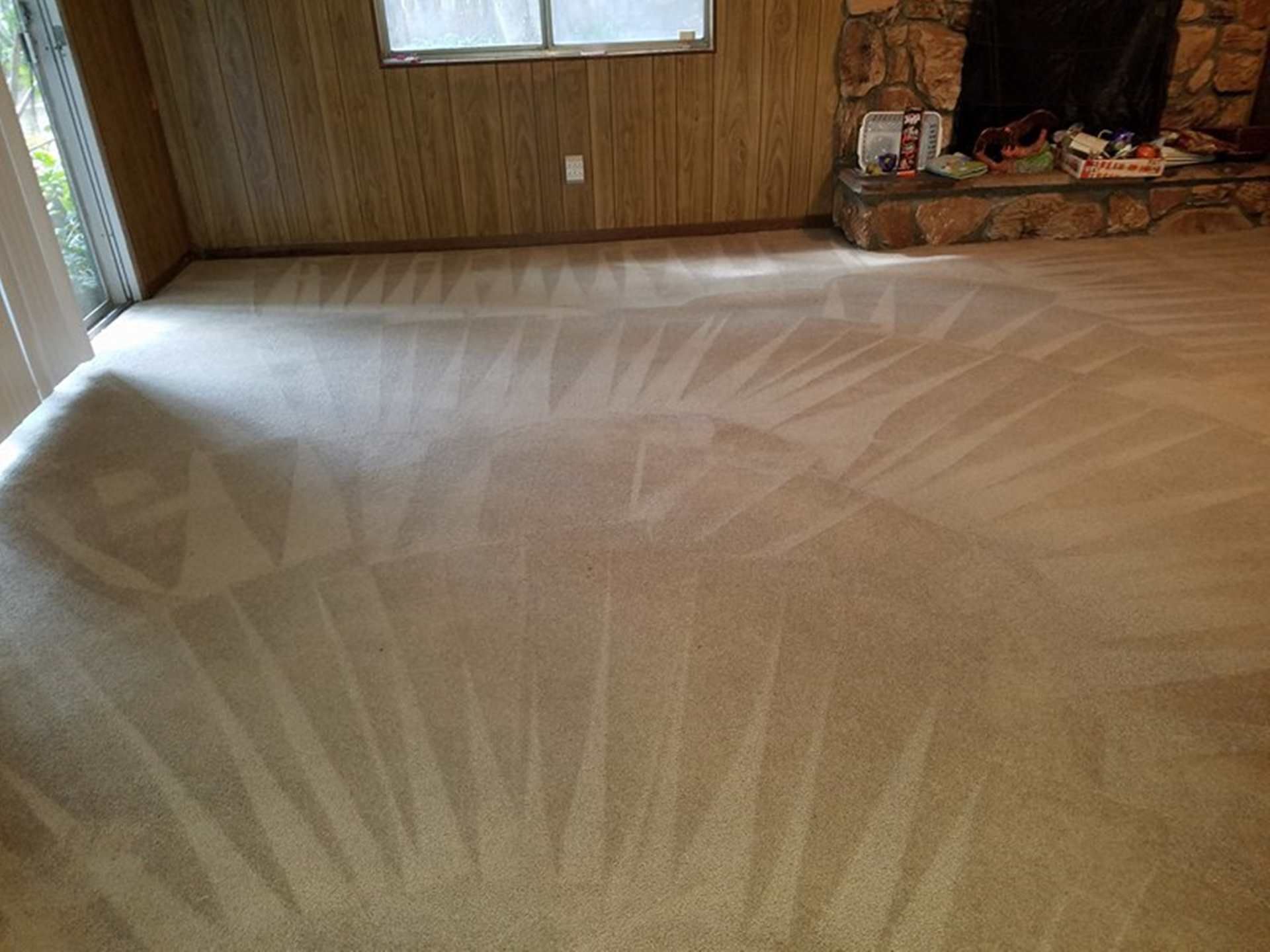 Living room with freshly vacuumed carpet patterns.