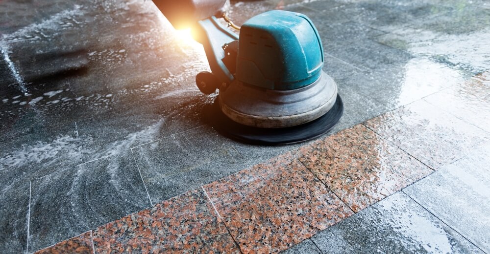 Cleaning the floor with a machine.