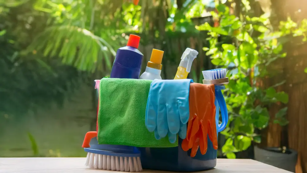 Outdoor cleaning supplies with gloves and brushes.